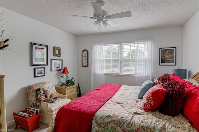 bedroom featuring a textured ceiling and a ceiling fan