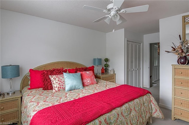 carpeted bedroom with a closet and a ceiling fan