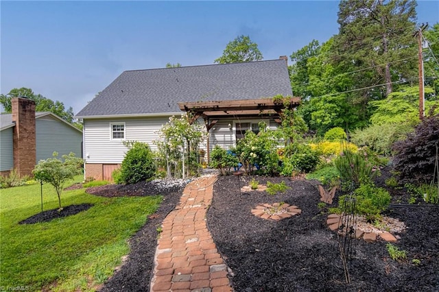 rear view of property with a lawn and a pergola