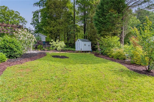 view of grassy yard with a storage unit and an outdoor structure