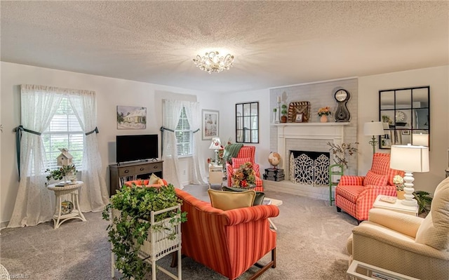 carpeted living area with a brick fireplace, a textured ceiling, and a chandelier
