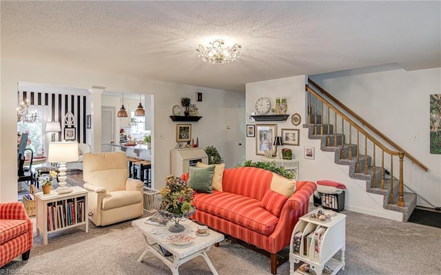 carpeted living room with a chandelier, stairway, and a textured ceiling