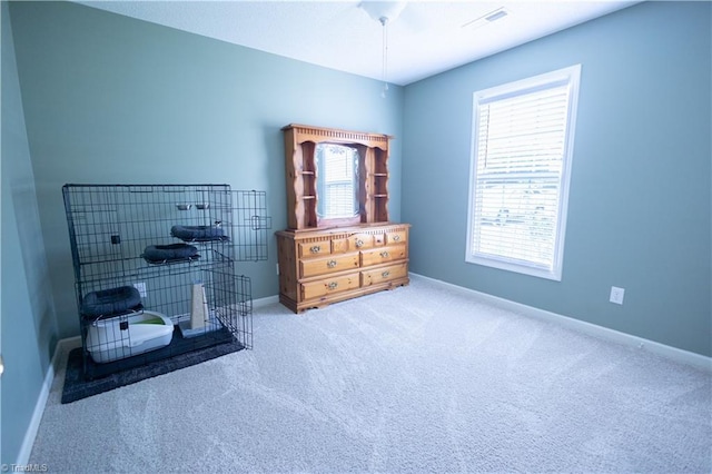 carpeted bedroom with multiple windows and baseboards