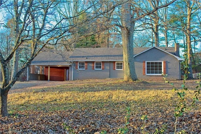 ranch-style home featuring a carport and a garage