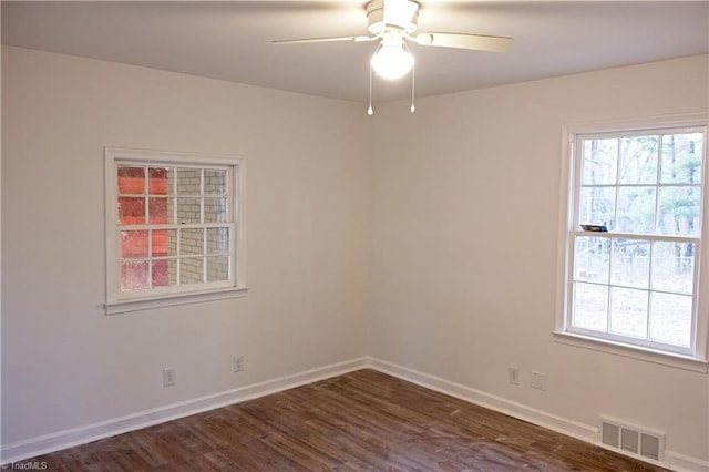 unfurnished room featuring dark wood-type flooring and ceiling fan