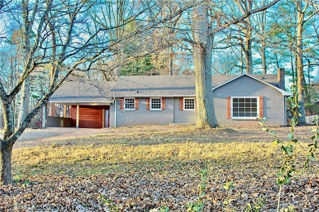 ranch-style home featuring a carport