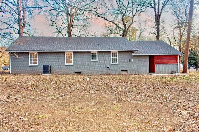 view of back house at dusk