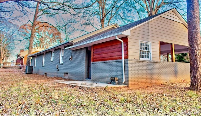 view of property exterior with central AC and a patio