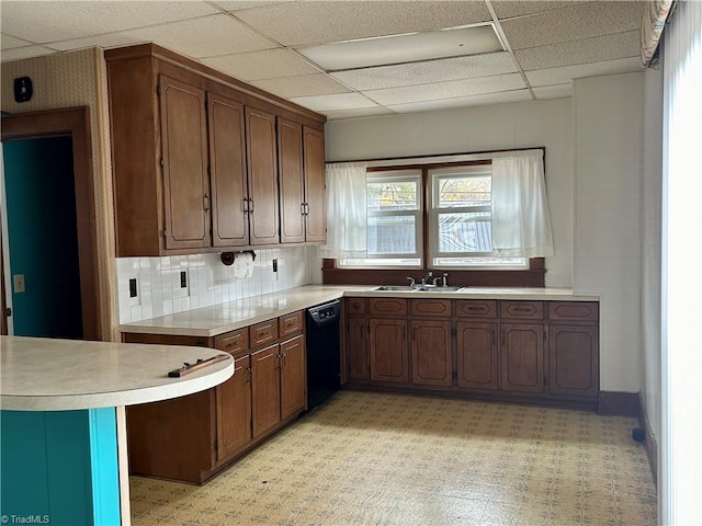 kitchen featuring dishwasher, a healthy amount of sunlight, sink, and a paneled ceiling