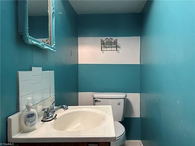 bathroom featuring toilet and vanity