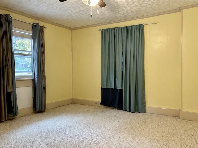 empty room featuring crown molding, a textured ceiling, carpet floors, and ceiling fan