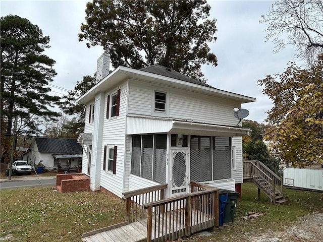 view of front of home with a sunroom