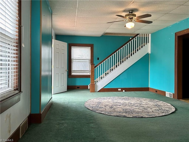 interior space featuring ceiling fan and carpet floors