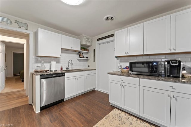 kitchen featuring white cabinetry, sink, stainless steel appliances, dark hardwood / wood-style flooring, and backsplash