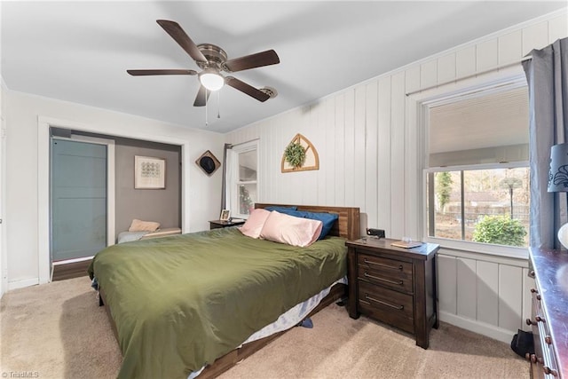 bedroom with light carpet and ceiling fan