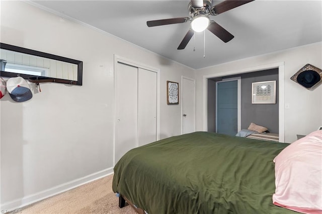 carpeted bedroom featuring a closet, ceiling fan, and ornamental molding