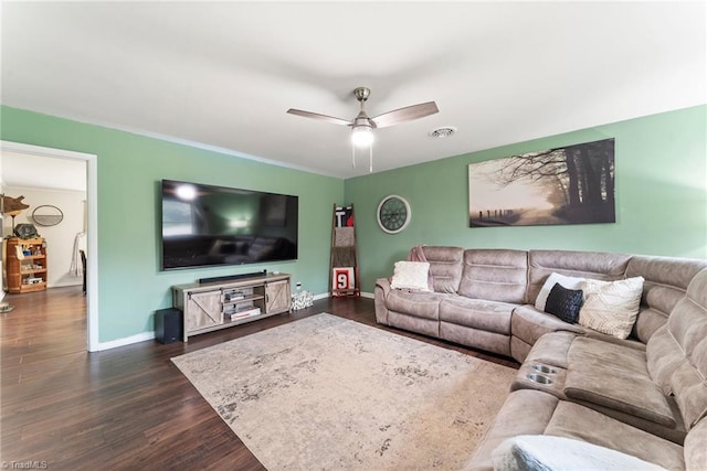 living room featuring ceiling fan and dark hardwood / wood-style floors