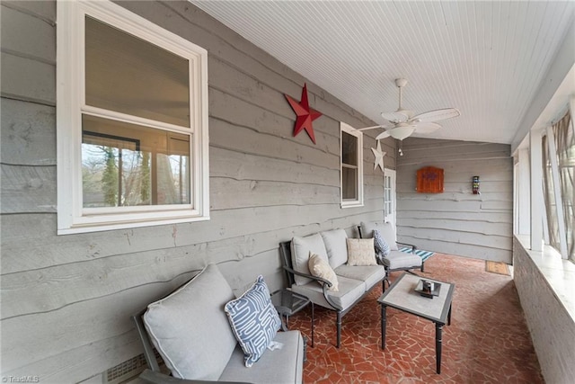 sunroom / solarium featuring ceiling fan and lofted ceiling