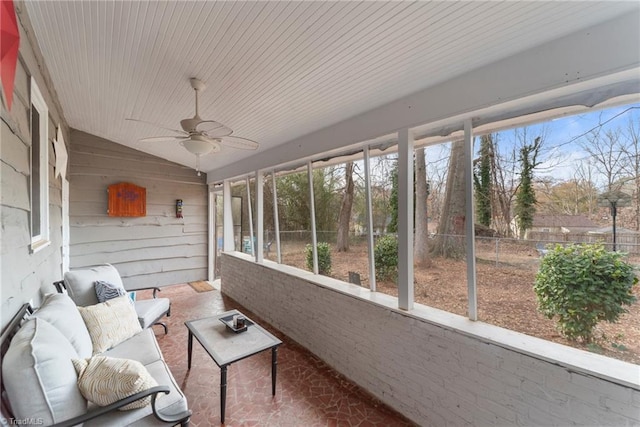 unfurnished sunroom featuring ceiling fan and lofted ceiling