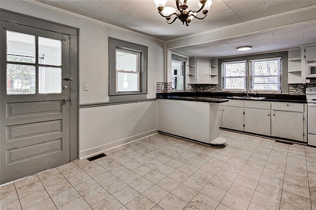 kitchen featuring visible vents, electric stove, dark countertops, open shelves, and backsplash