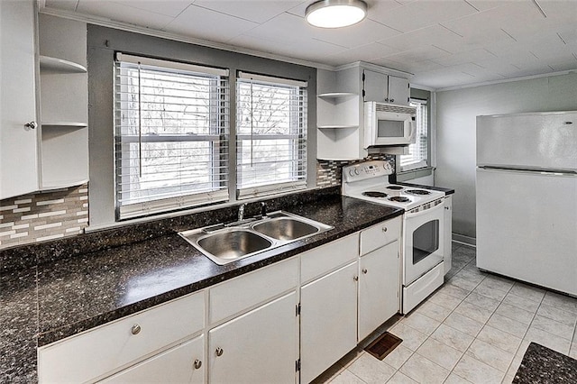 kitchen featuring white appliances, a sink, decorative backsplash, open shelves, and dark countertops