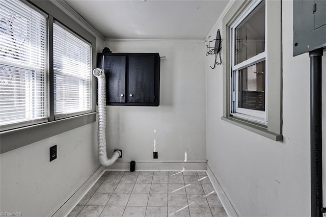 clothes washing area featuring light tile patterned floors, cabinet space, ornamental molding, hookup for an electric dryer, and baseboards