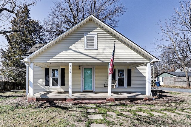 bungalow-style house with fence and a porch