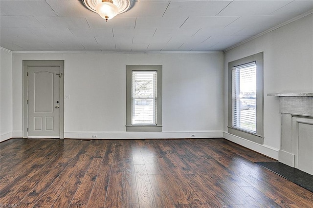 unfurnished living room featuring ornamental molding, baseboards, and wood finished floors