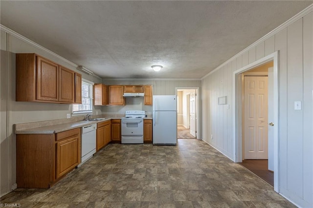 kitchen with crown molding, sink, and white appliances