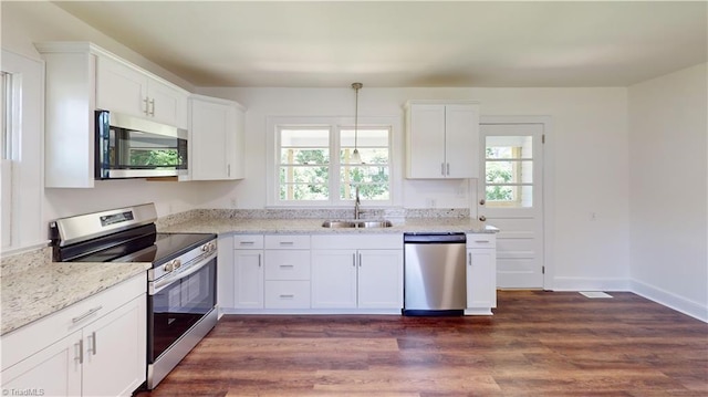 1023 Spring St, Mount Airy, NC 27030 - kitchen with stainless steel appliances, dark wood finished floors, white cabinetry, and light stone counters