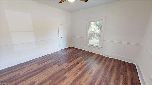 1023 Spring St, Mount Airy, NC 27030 - unfurnished room with a ceiling fan, dark wood-style flooring, and a wainscoted wall