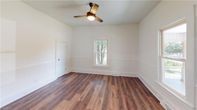 1023 Spring St, Mount Airy, NC 27030 - spare room with dark wood finished floors, ceiling fan, and wainscoting