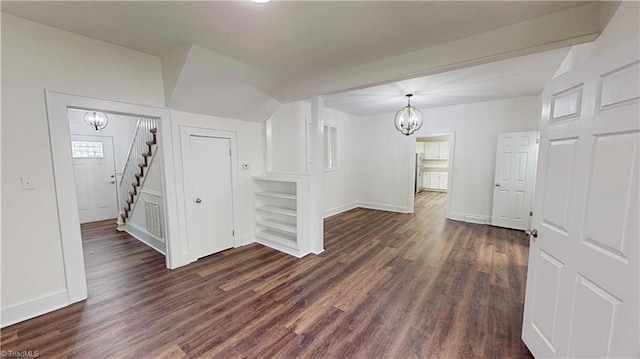 1023 Spring St, Mount Airy, NC 27030 - spare room featuring a chandelier, dark wood-type flooring, stairway, and vaulted ceiling