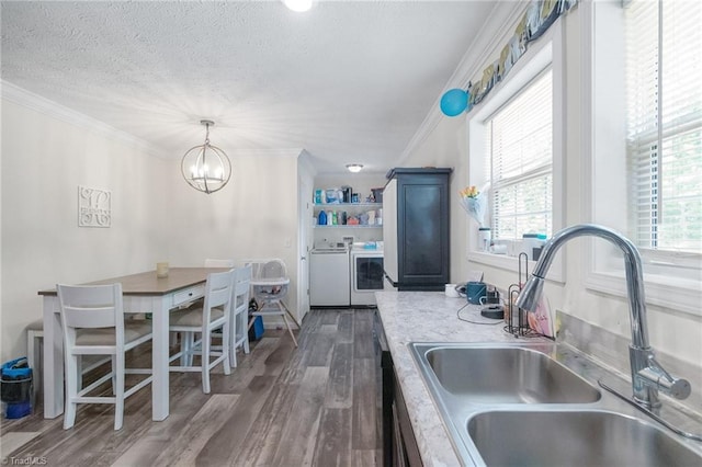 kitchen with separate washer and dryer, a textured ceiling, plenty of natural light, and a sink