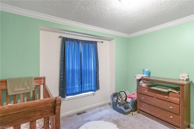 carpeted bedroom featuring crown molding, a textured ceiling, visible vents, and baseboards