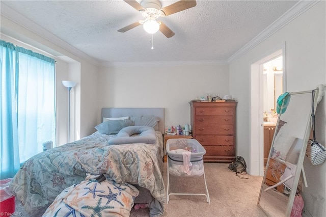 bedroom featuring light colored carpet, ornamental molding, a textured ceiling, and a ceiling fan