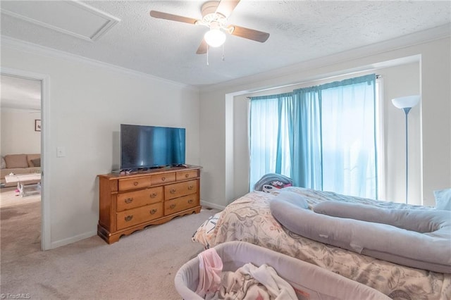 carpeted bedroom with crown molding, baseboards, ceiling fan, and a textured ceiling