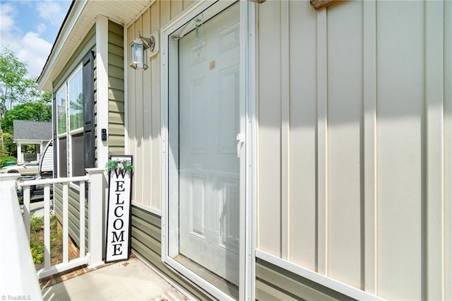 view of exterior entry featuring board and batten siding