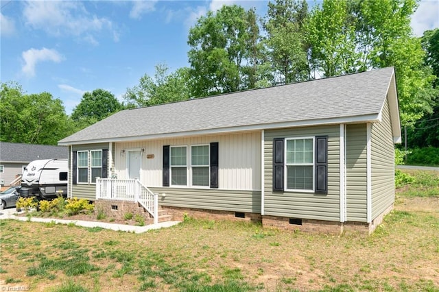 ranch-style house featuring a shingled roof, a front yard, and crawl space