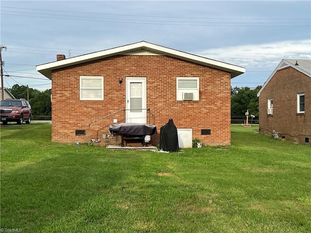 back of house with a lawn