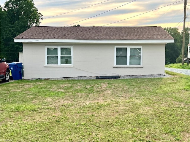 6327 Blazing Star Dr, Archdale, NC 27263 - property exterior at dusk featuring a lawn, a shingled roof, and concrete block siding