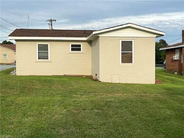 back of property featuring a lawn