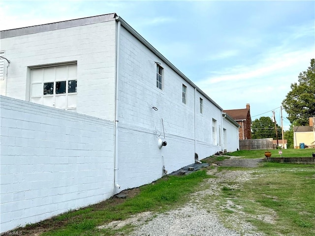 view of side of home with a yard