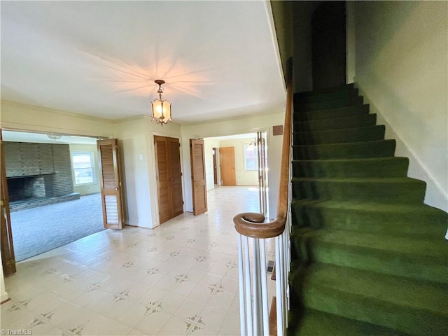 staircase featuring light colored carpet and a chandelier