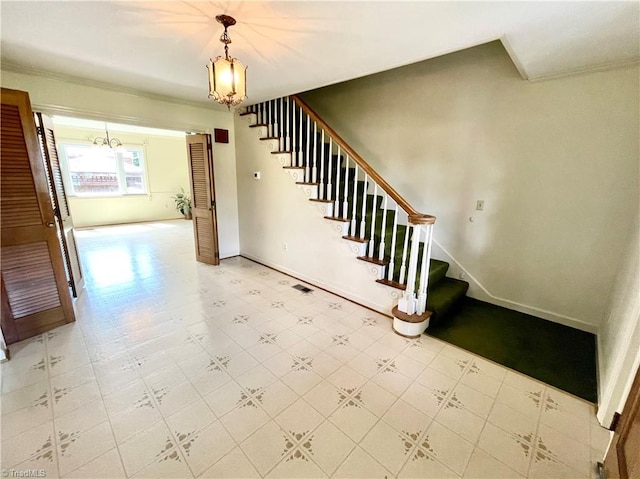 interior space featuring light tile patterned flooring, crown molding, and a notable chandelier