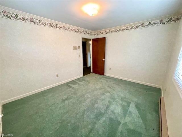 empty room with carpet flooring and crown molding