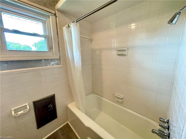 bathroom with shower / tub combo and tile walls