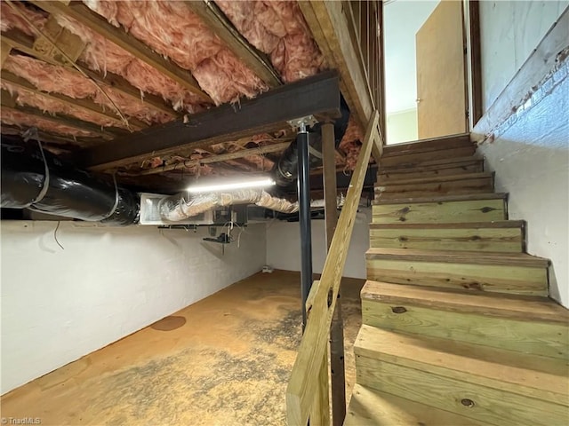 stairway with concrete flooring