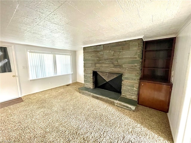 unfurnished living room with carpet floors and a stone fireplace