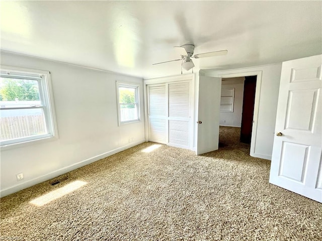 unfurnished bedroom featuring light carpet, a closet, and ceiling fan